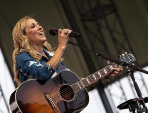 Sheryl Crow onstage with acoustic guitar