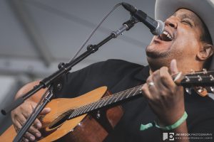 Chris Pierce sings and plays guitar onstage at Newport Folk Festival