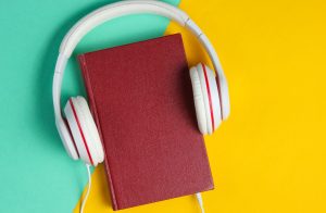 Image of a book with headphones around it